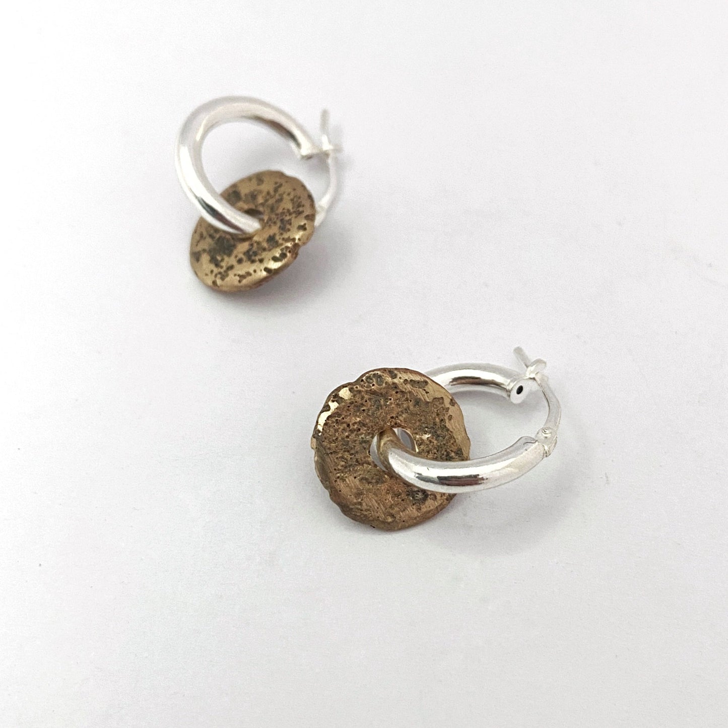 Textured donut element in bronze on silver hoop by Savage Jewellery