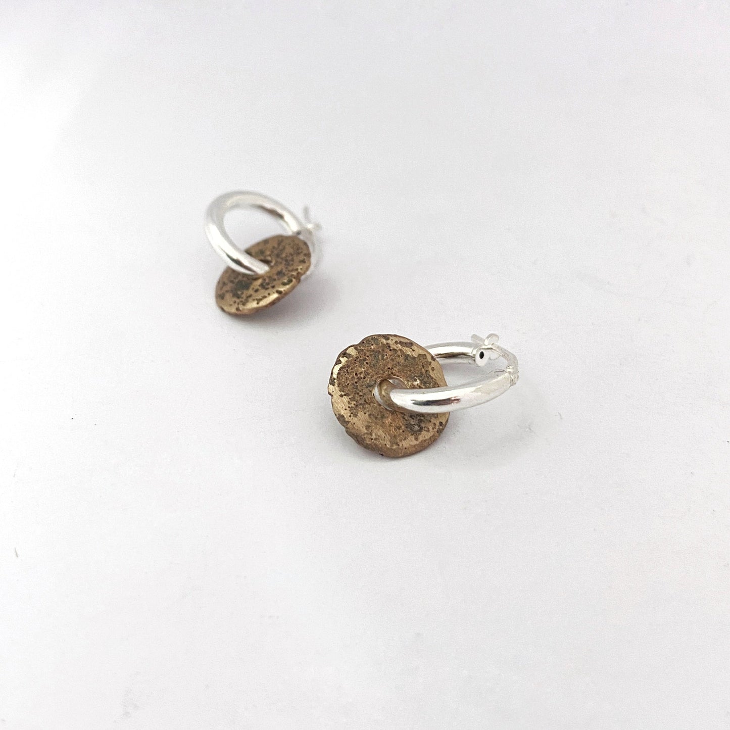 Sandcast donut element on silver hoop by Savage Jewellery