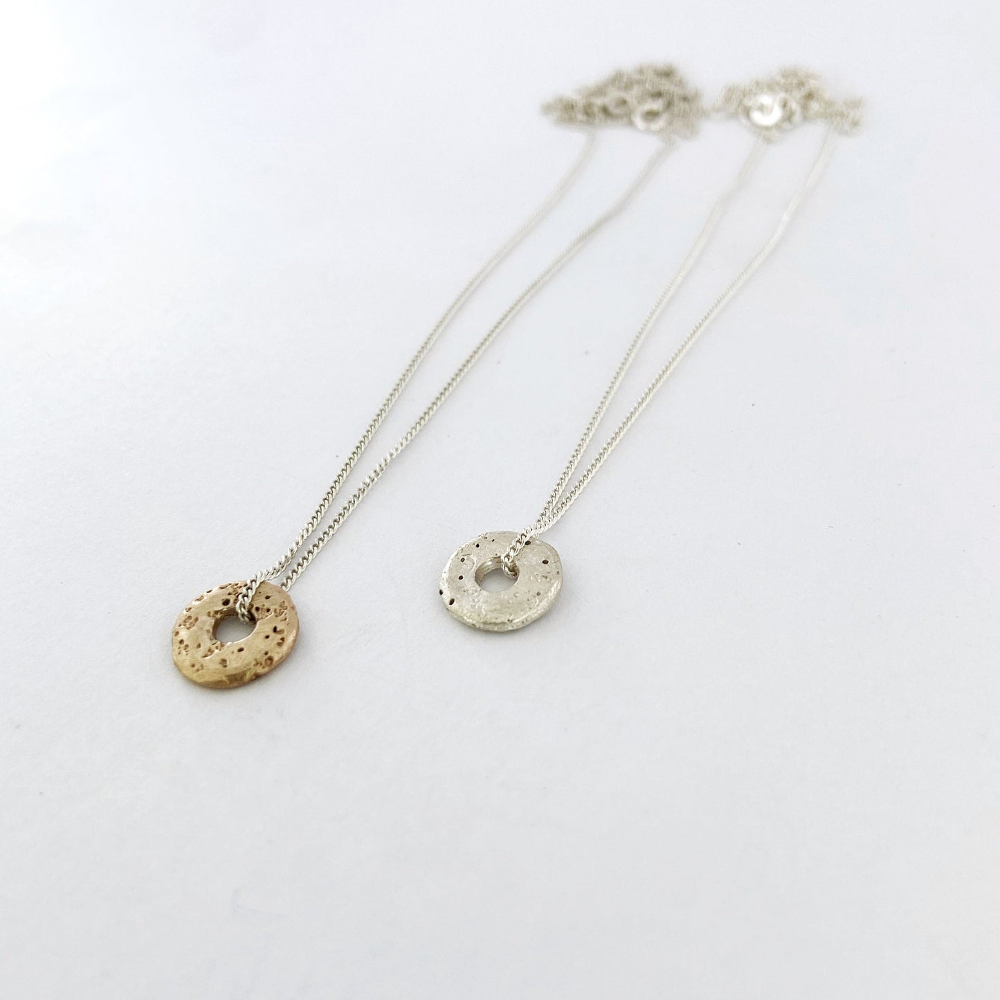 Textured sand cast pendant in silver and gold by Savage Jewellery