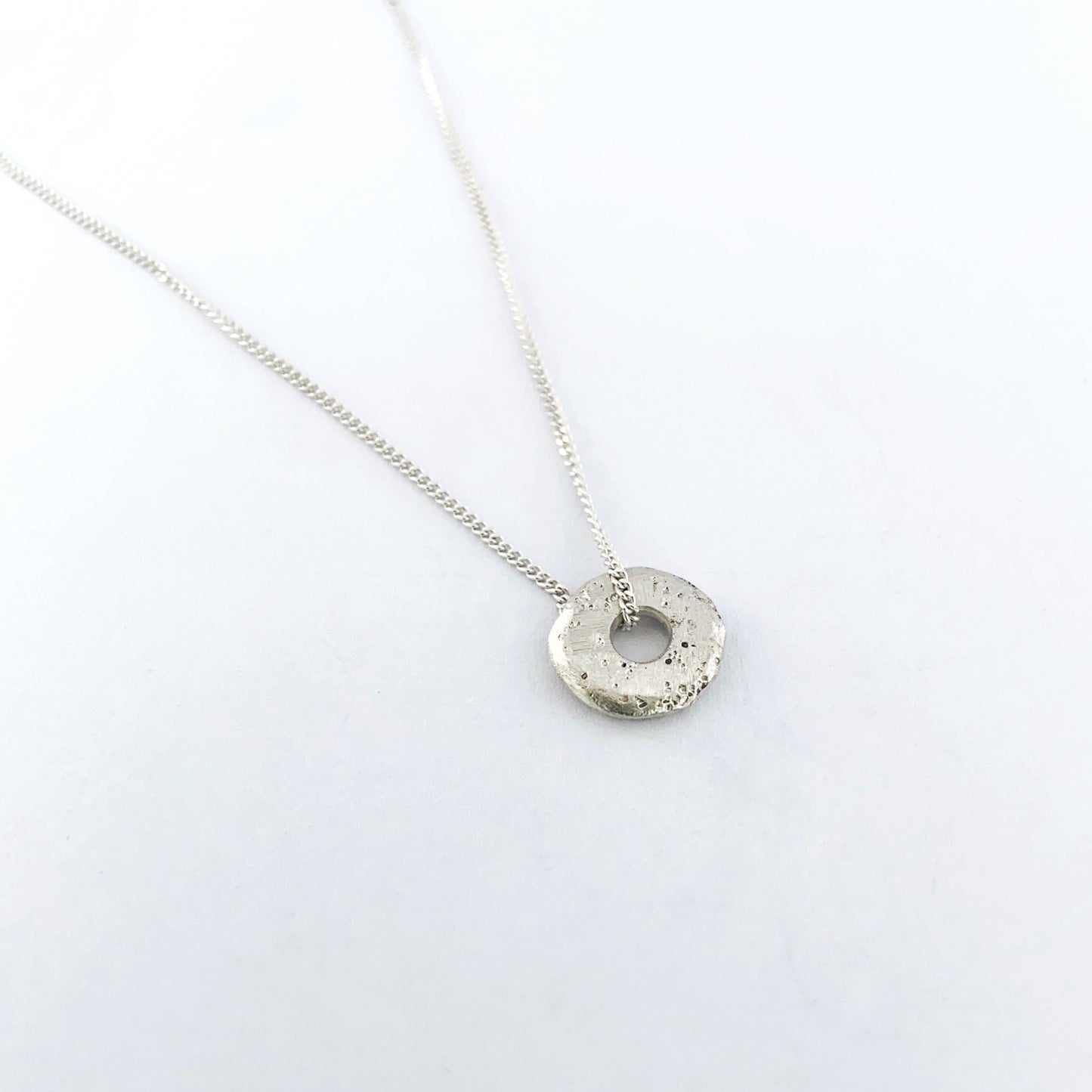 small textured sand cast donut pendant on chain by Savage Jewellery