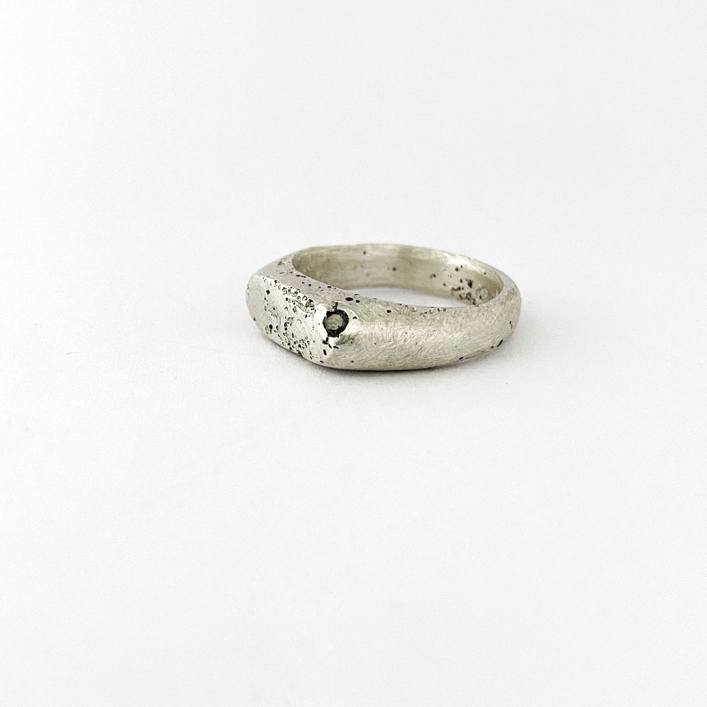 handmade Sandcast oval signet style ring with salt and pepper diamond