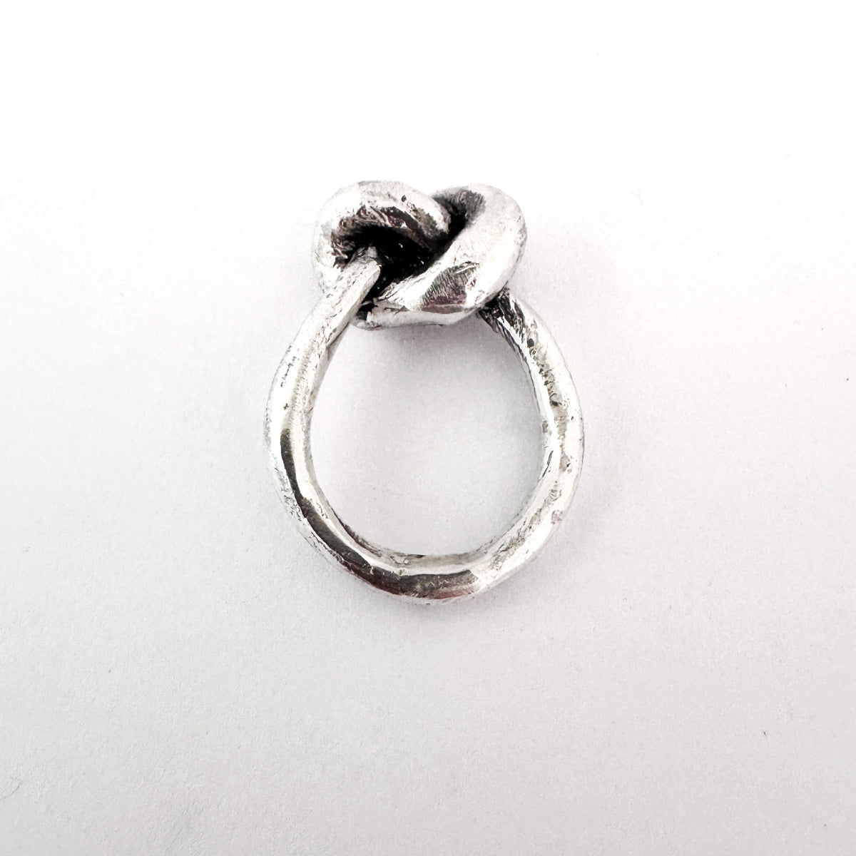Silver ring with a unique design on a white background