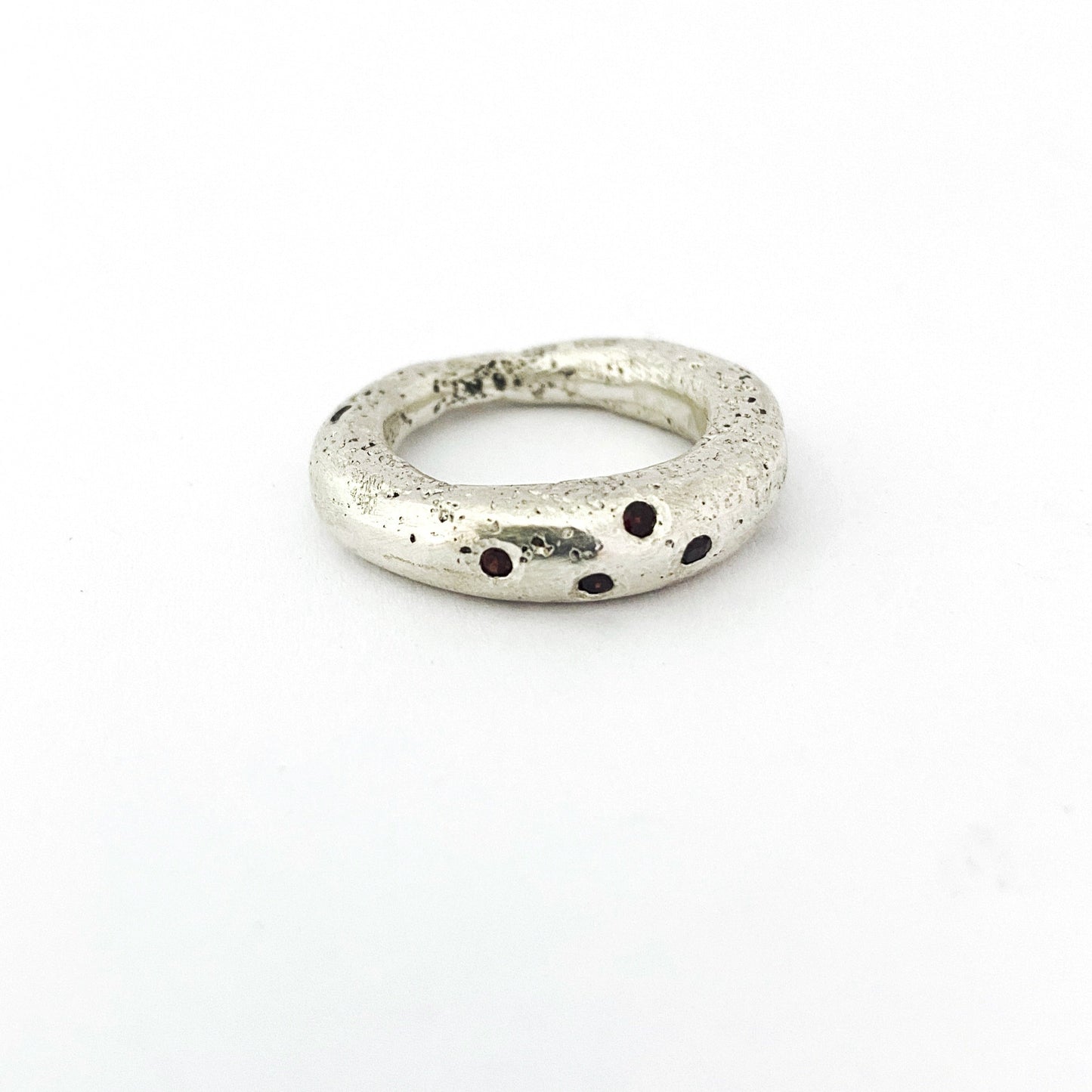 textured sand cast ring with garnets by Savage jewellery