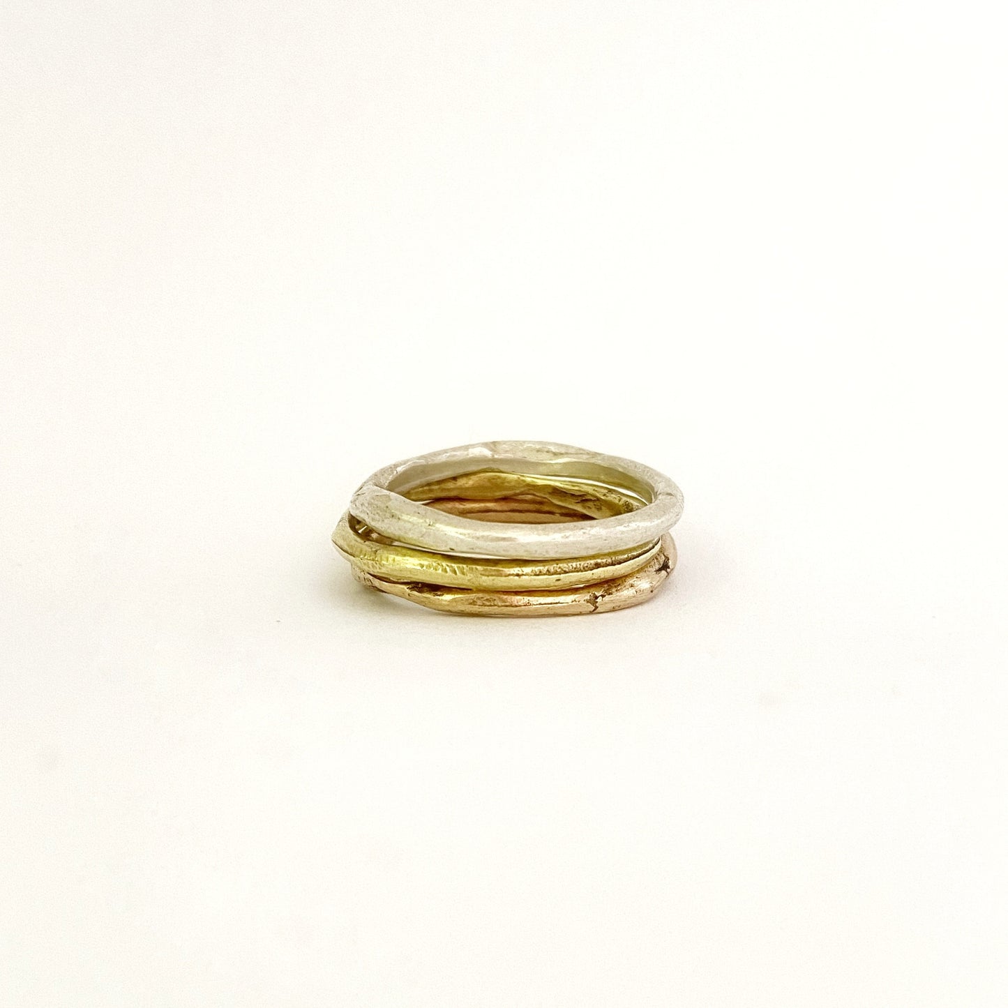 Silver, brass and bronze organic stacking rings by Savage Jewellery