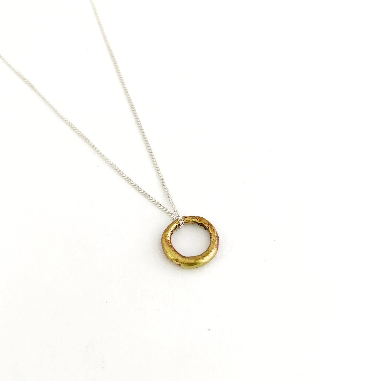 brass circle pendant on silver chain