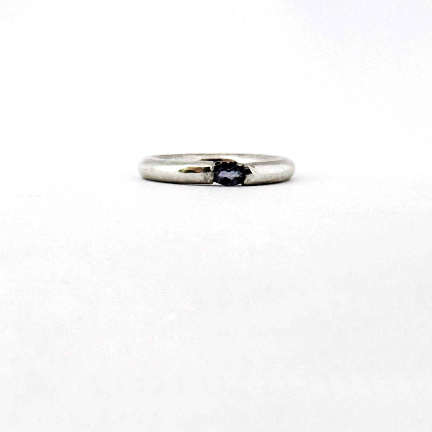 3mm wide silver ring with oval iolite set in a floating like setting by South African designer Savage Jewellery