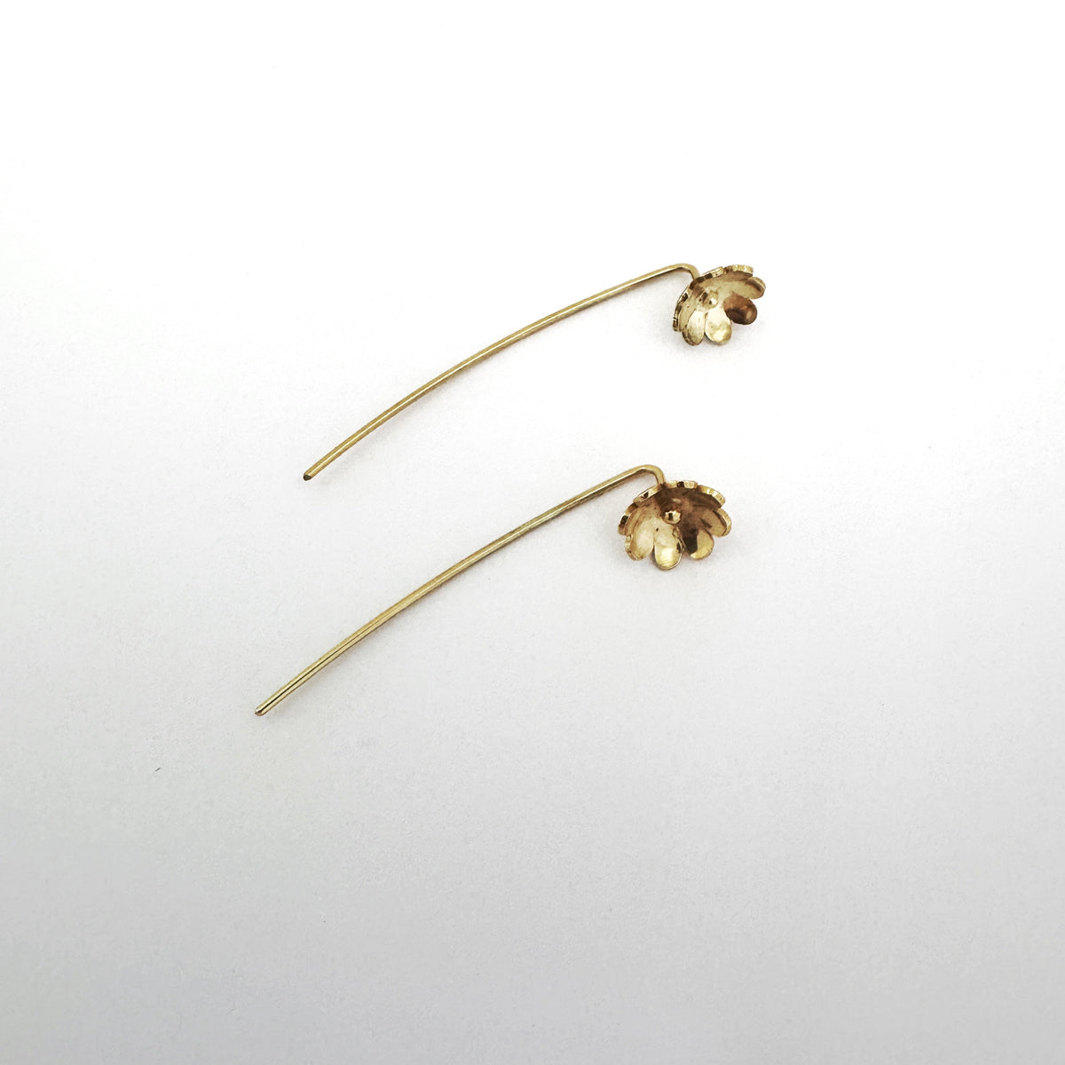 Gold plated sterling silver daisy stick earrings, flower on earlobe with stick behind