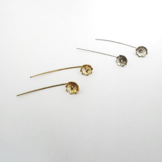 Sterling silver and gold daisy stick earrings, flower on earlobe with stick behind