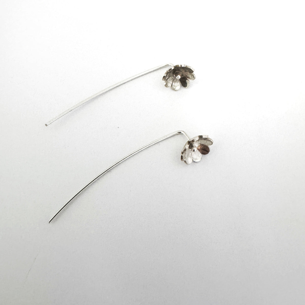 Sterling silver daisy stick earrings, flower on earlobe with stick behind