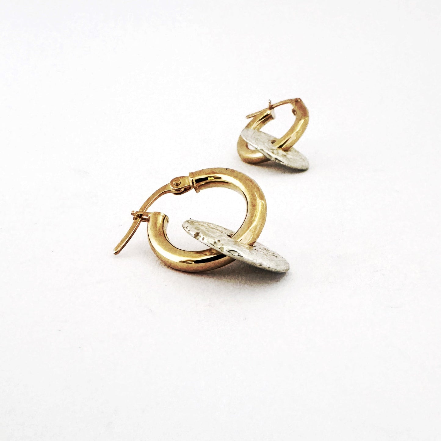 Silver and gold hoop style earring by South African designer, Savage Jewellery