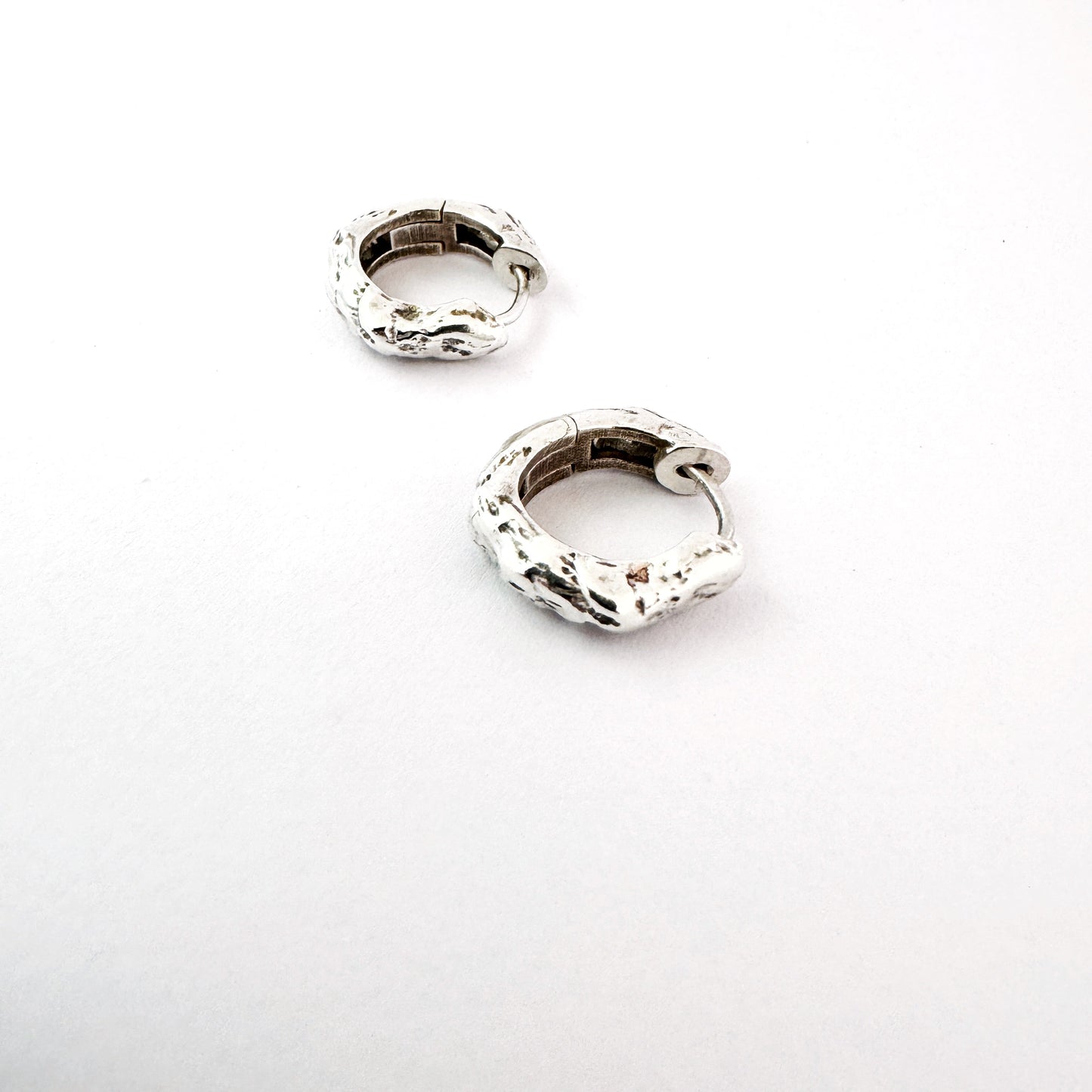 Sterling silver organic hoop earrings on a white background by Savage Jewellery