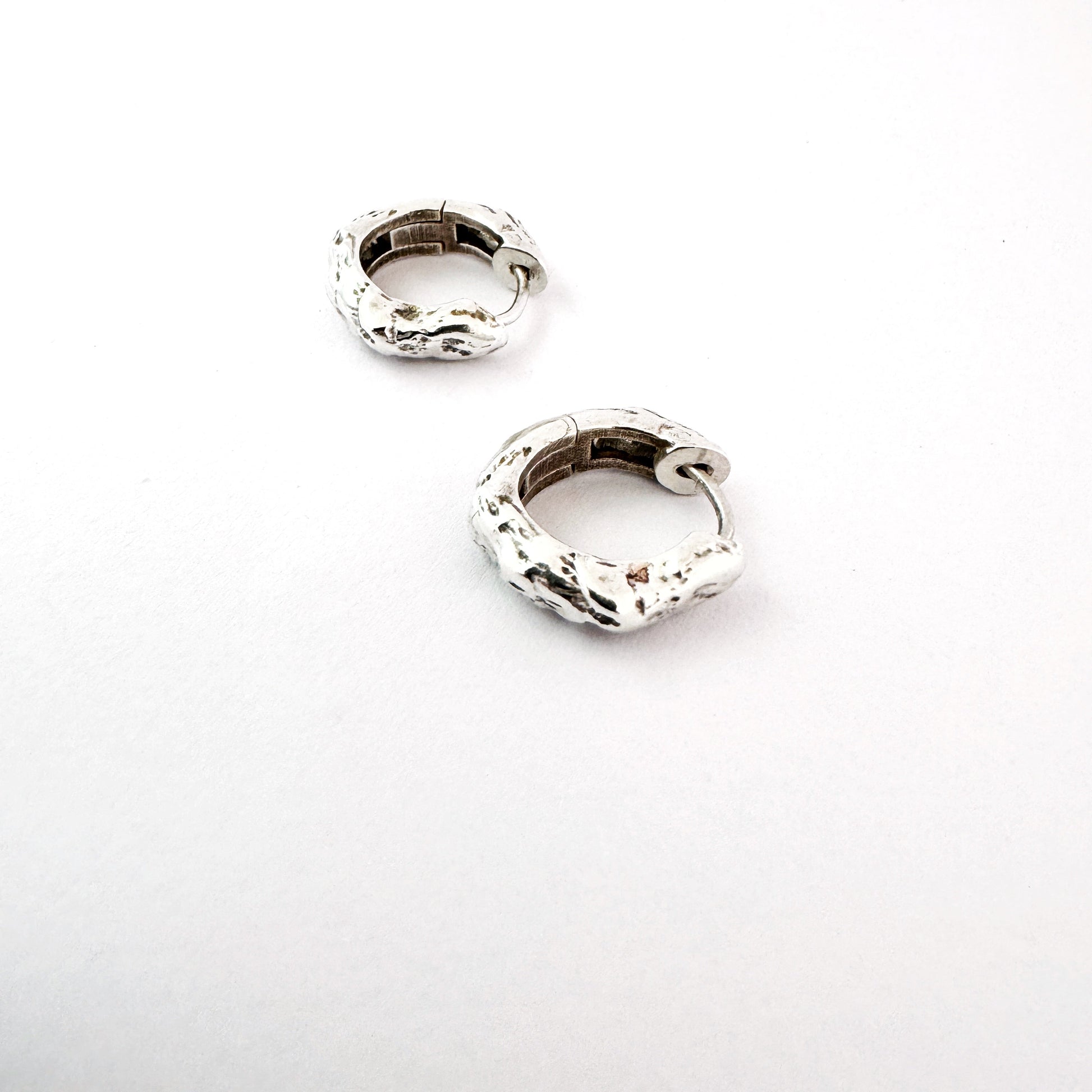 Sterling silver organic hoop earrings on a white background by Savage Jewellery