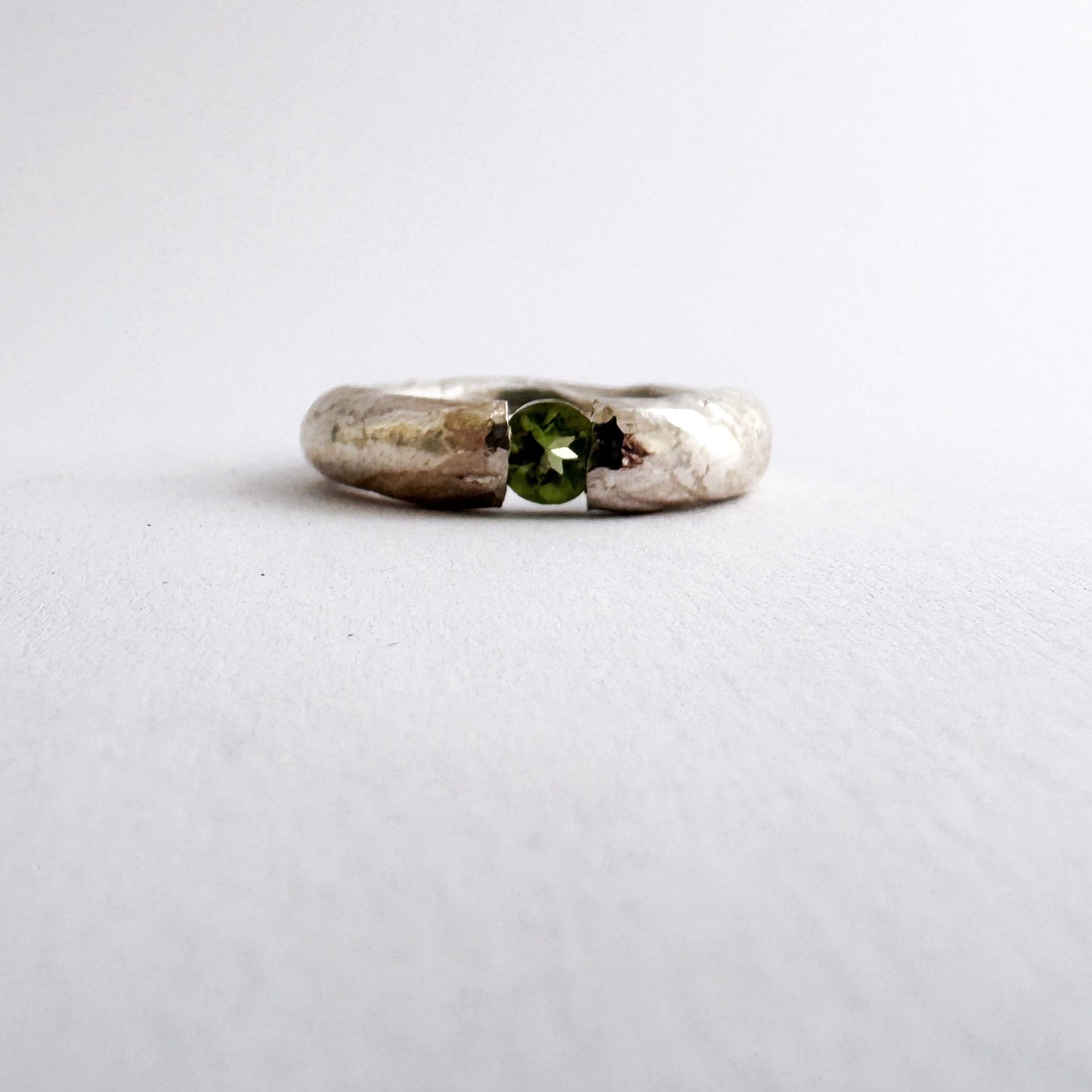 Textured silver ring with floating peridot