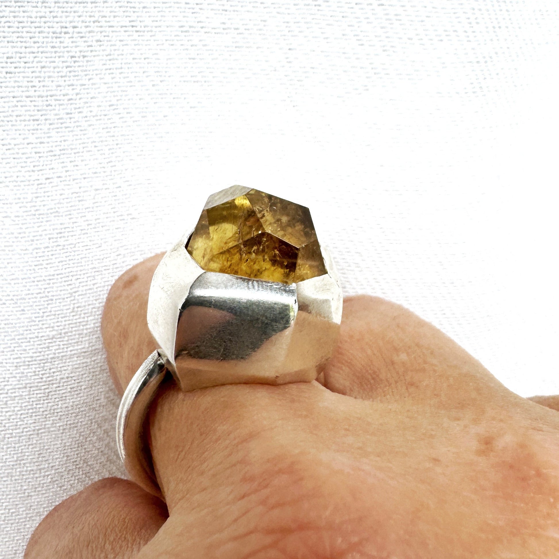 Custom cut citrine with large angular facets set in a chunky silver ring by Savage Jewellery