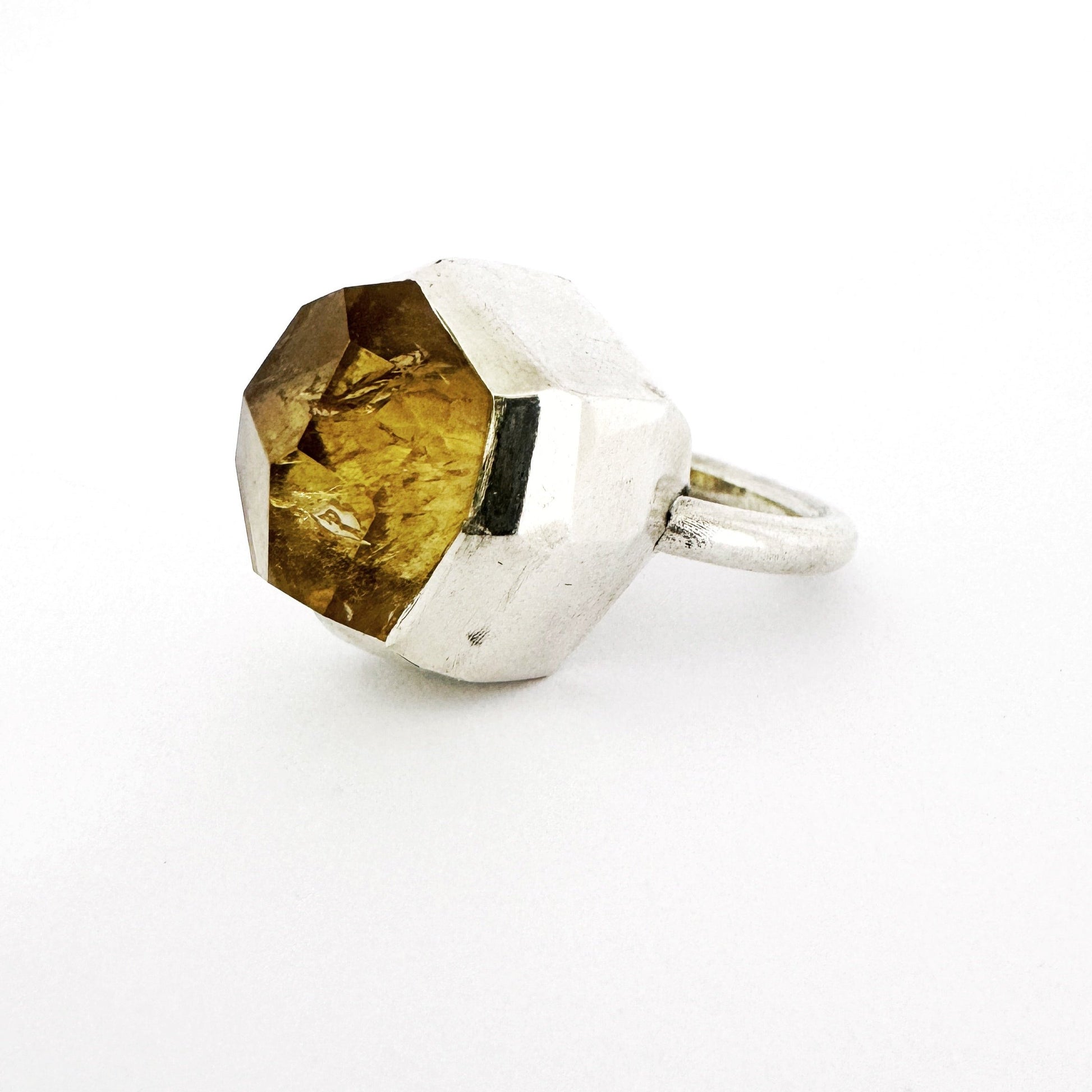 Modern chunky silver ring with a custom cut citrine with large angular facets set in a silver ring by Savage Jewellery