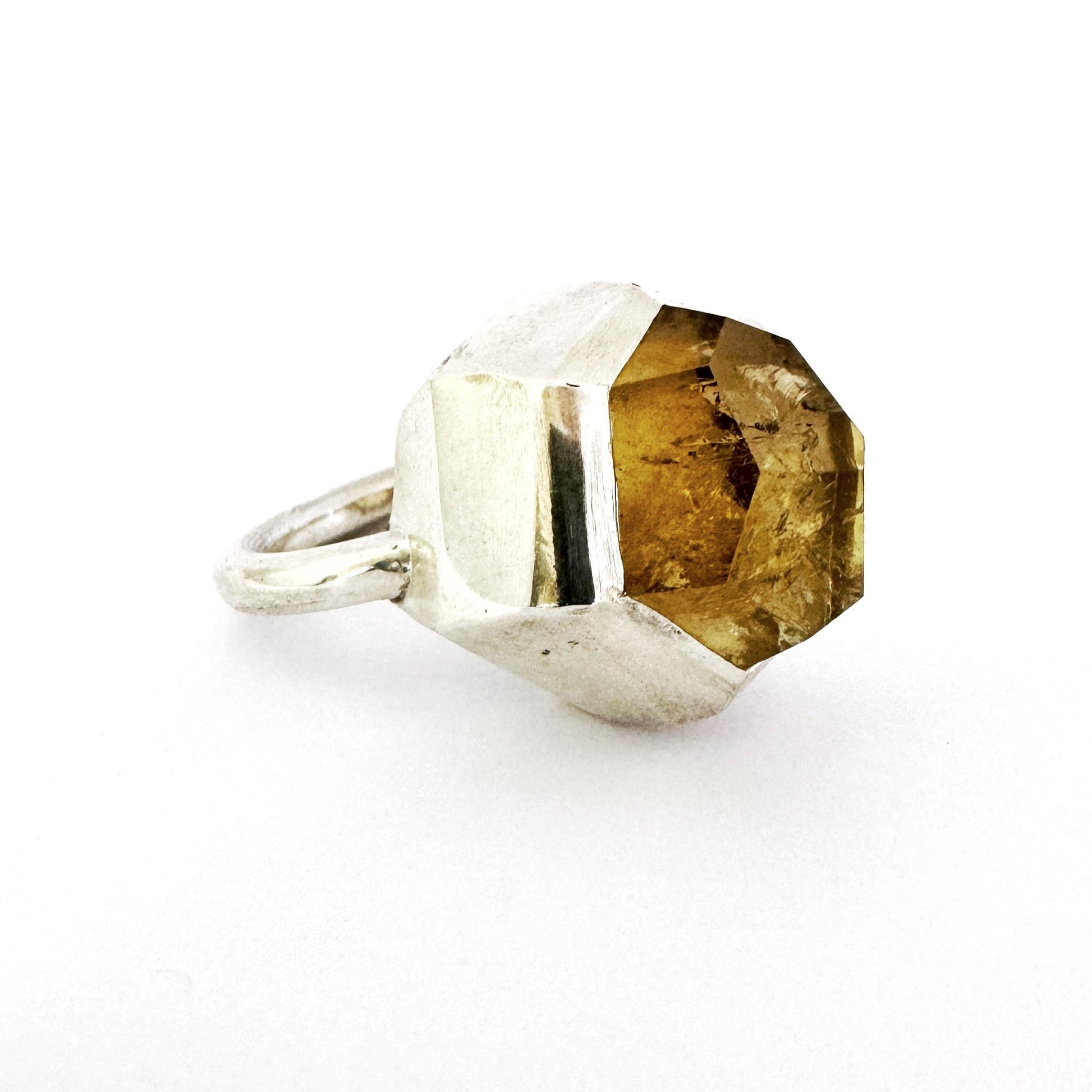 Custom cut citrine with large angular facets set in a chunky contemporary silver ring by Savage Jewellery