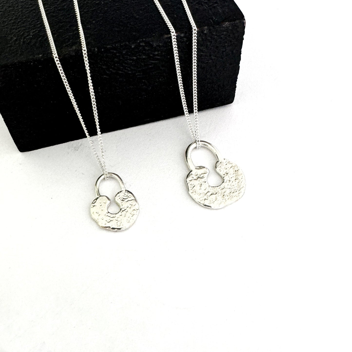 Medium and large lock style pendants in sterling silver by Savage Jewellery