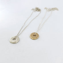 Textured sand cast donut necklace in silver and yellow gold by contemporary jeweller Savage Jewellery