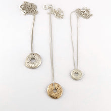 Small, medium and large sandcast donut pendant on chains by contemporary designer Savage Jewellery
