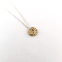 Small gold sand cast donut pendant on chain by Savage Jewellery