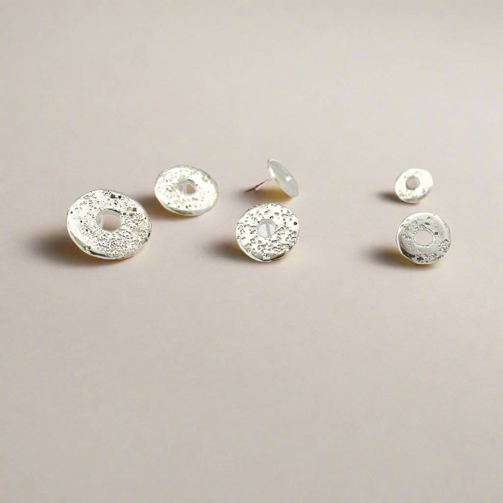 Donut style button earrings with a sandcast texture in small, medium and large by designer Savage Jewellery