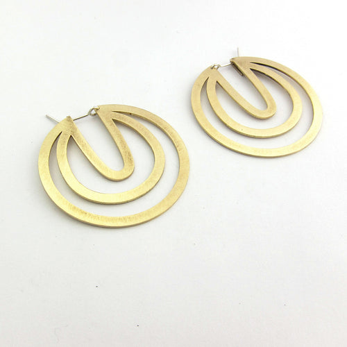 Modern designer earrings, brass cut out disks - a large hoop style earring