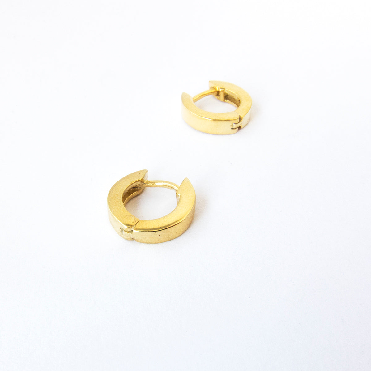 simple yellow gold huggies by Savage Jewellery