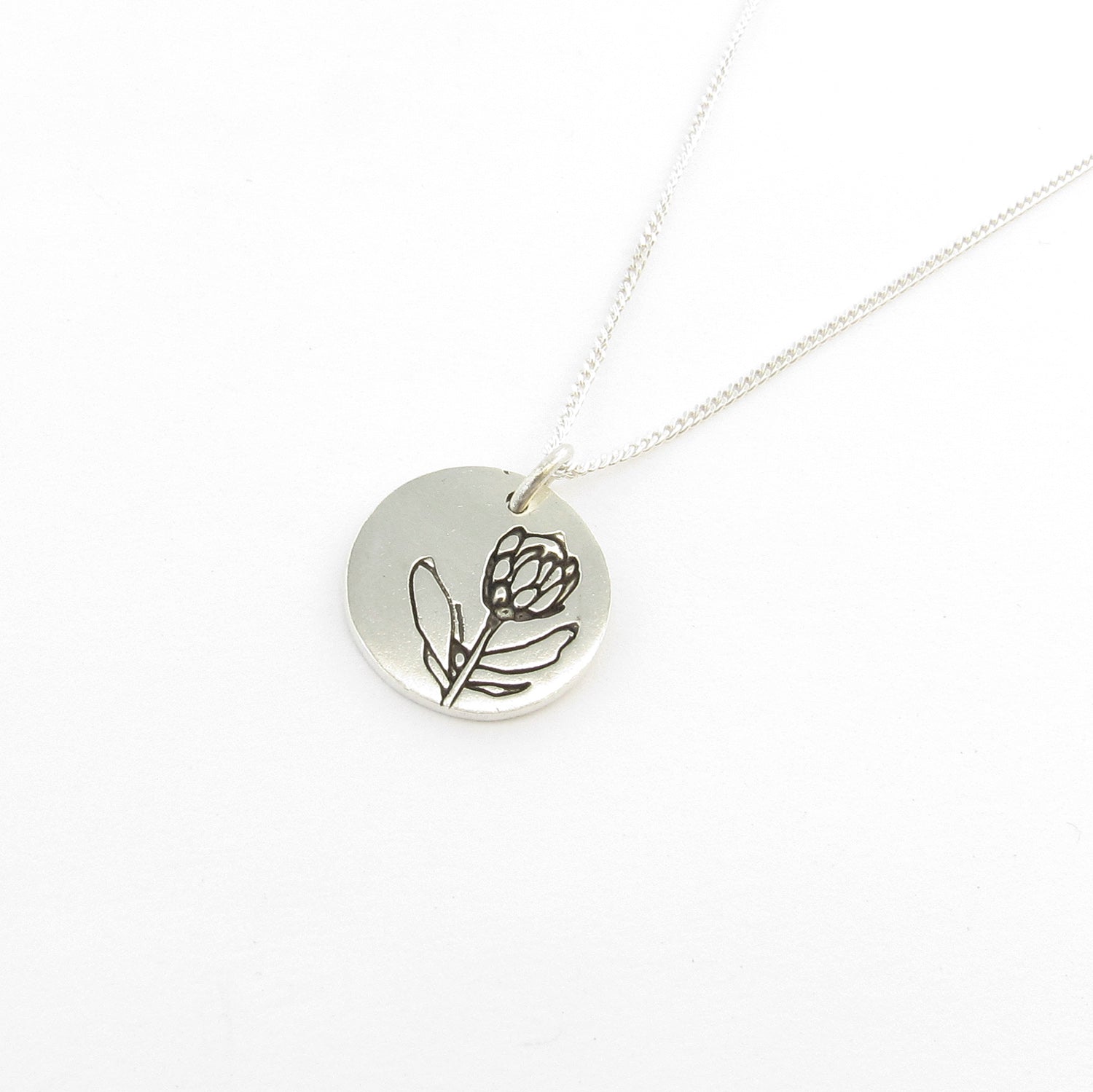 Protea disk on chain this is part of the Icon Africa range designed in Durban South Africa by Savage Jewellery