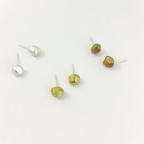 Nugget stud earrings in silver, brass and bronze on white background
